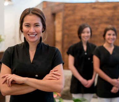 Medspa employees smiling in their front office